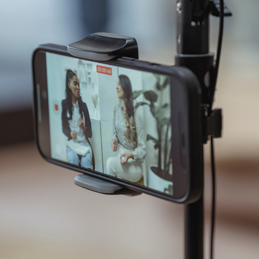 Phone on a tripod recording two people for social media